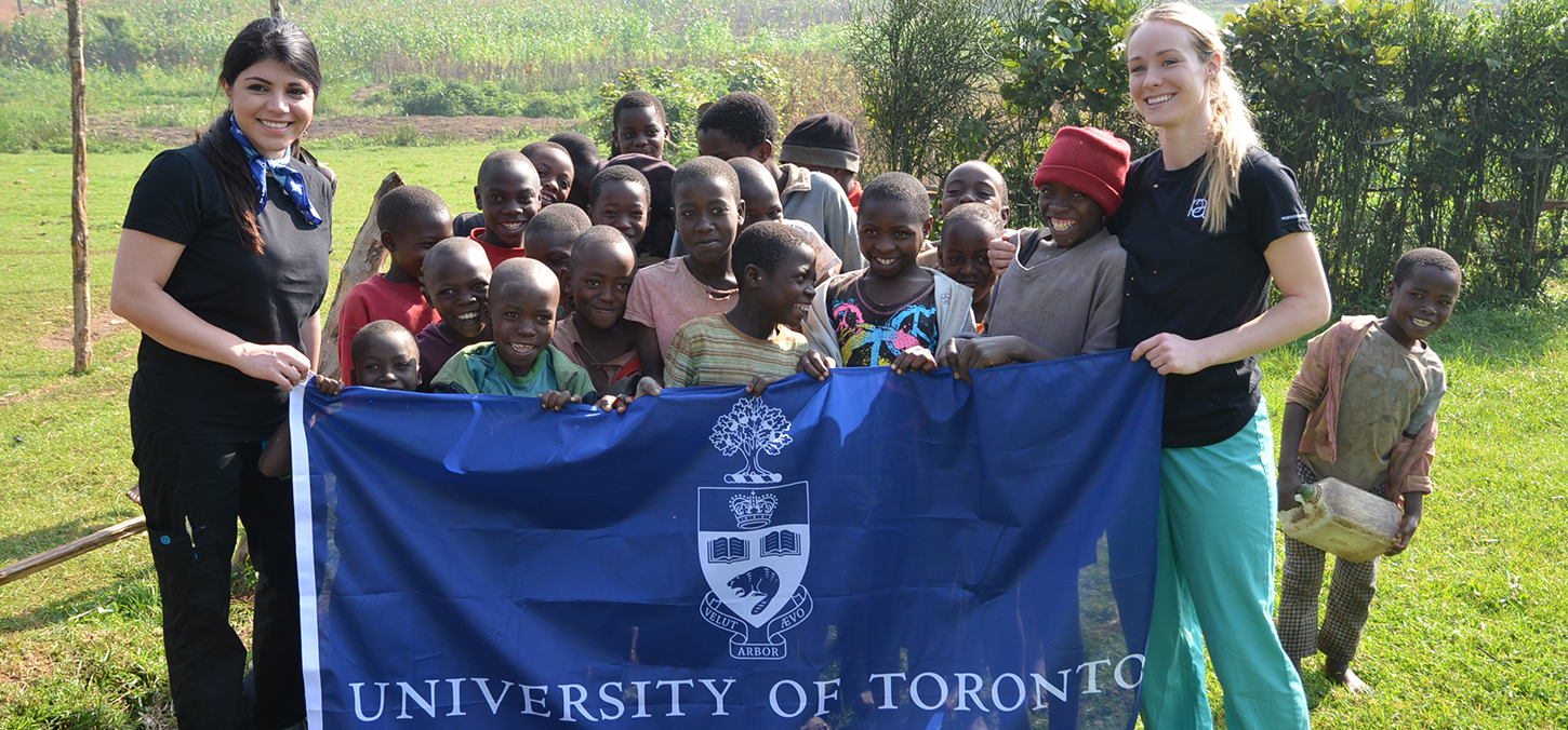 students with locals hold UofT Dentistry flag