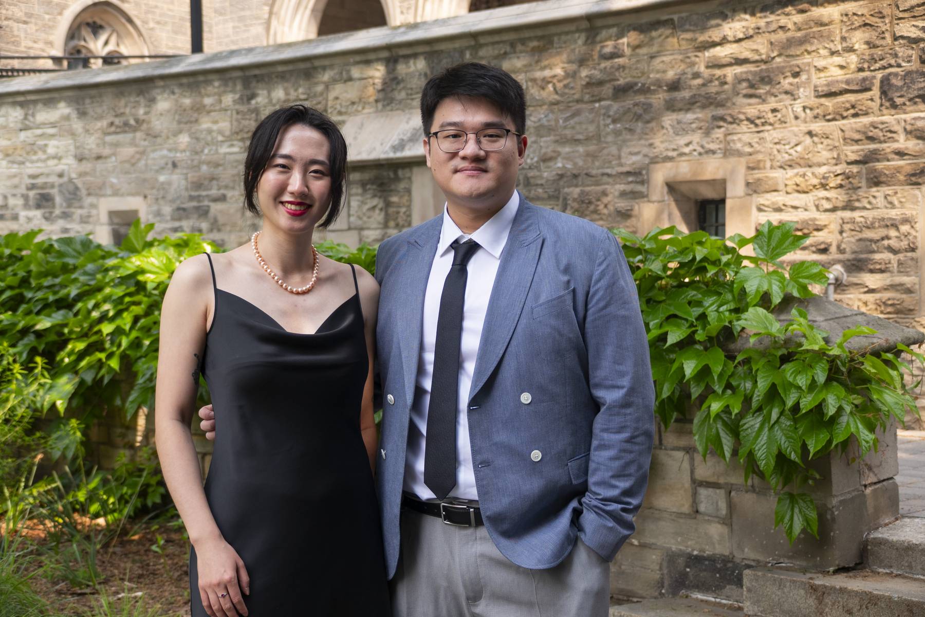 two students standing smiling