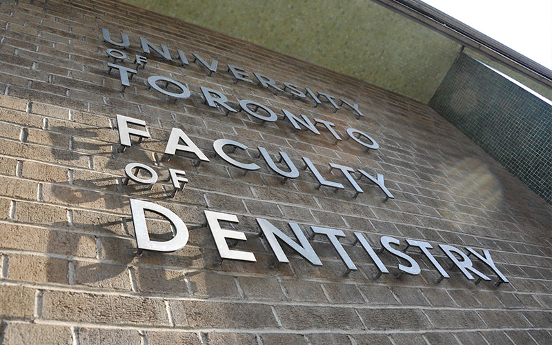 The sign on the side of the building stating 'University of Toronto Faculty of Dentistry'