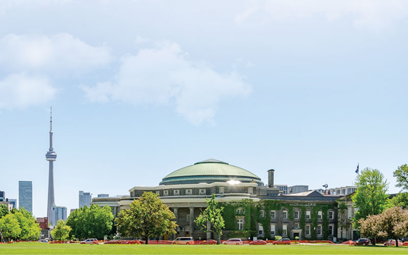 A photo of UofT campus with the CN Tower in the background