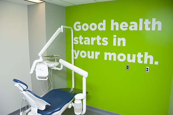 green wall with stencilled words: Good health starts in your mouth