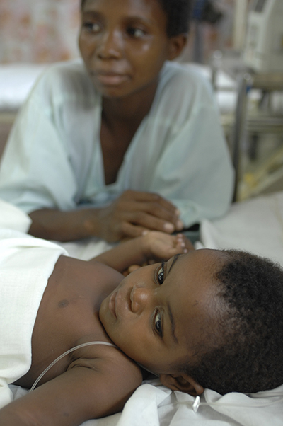 Mother and boy on bed in Kenya