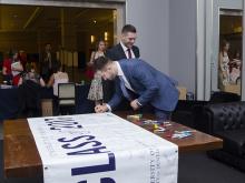 students sign class banner