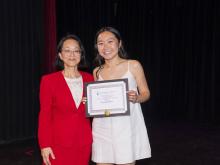 two people smiling and holding award