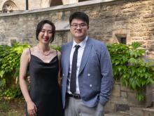 two people standing outside smiling