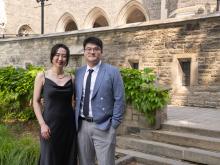 two people standing outside smiling