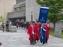 graduate procession walking in robes