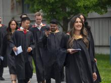 graduate students walking in robes