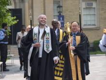 people walking in robes