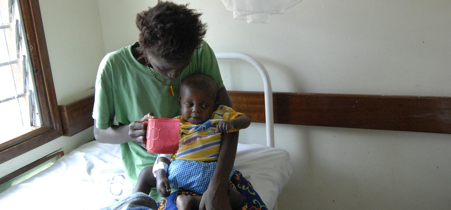Mother and child on a bed at Kenya Medical Research Institute 