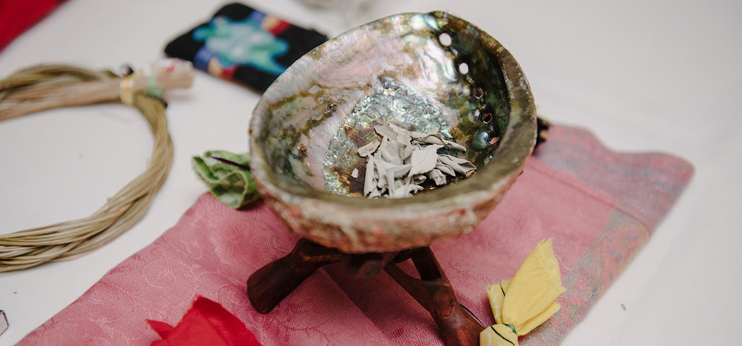 Indigenous smudge bowl on ceremonial cloth