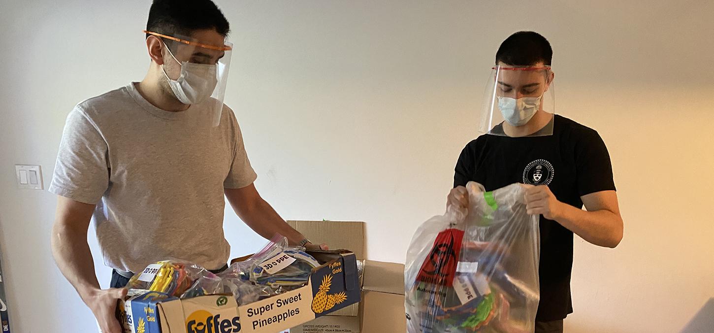 student volunteers package face shields for delivery