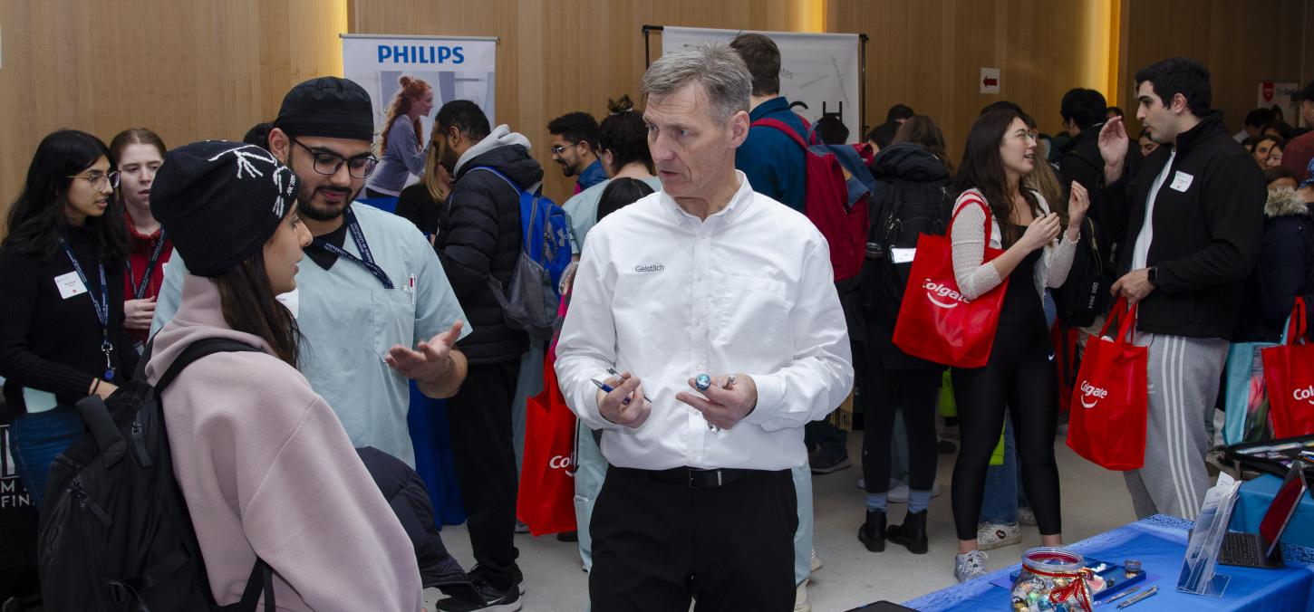 Photo of students interacting with sponsors at the Student Vendor Fair.