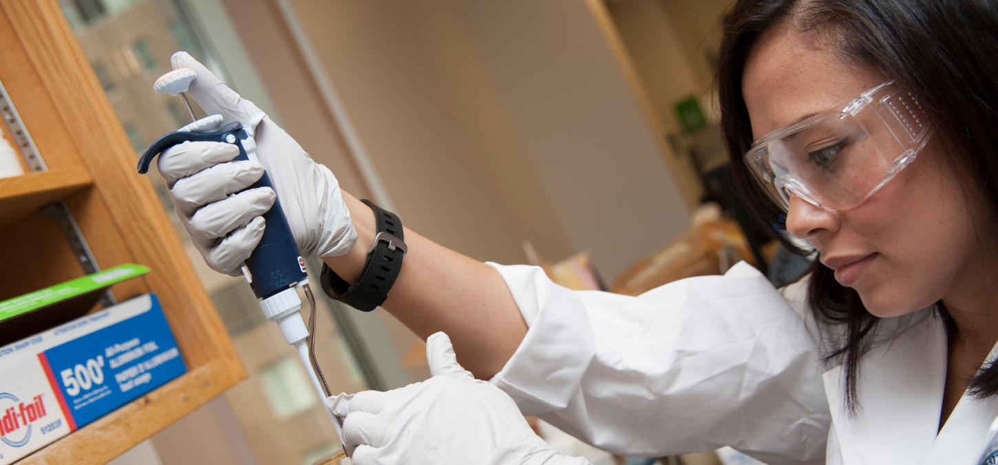 Karina using lab equipment in lab
