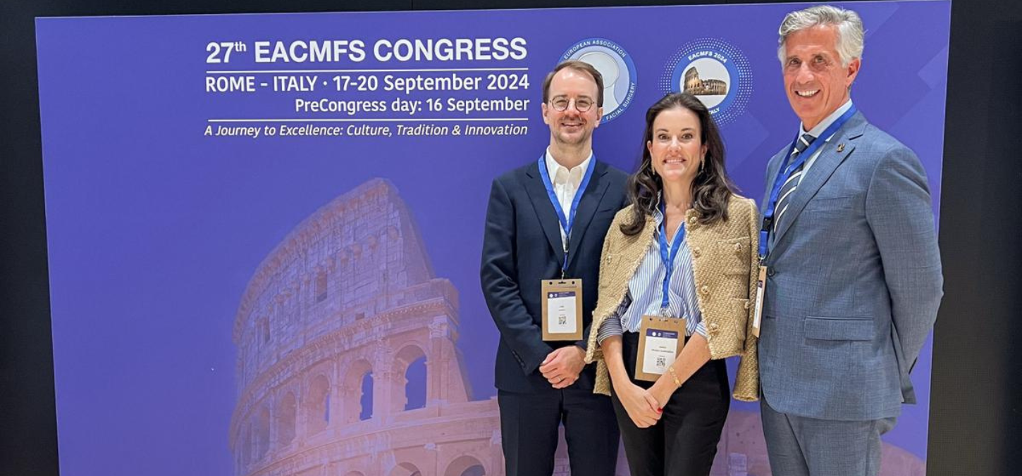 Dr. Caminiti (right), Dr. Cuddy (left), and Dr. Franco (centre) in front of a banner