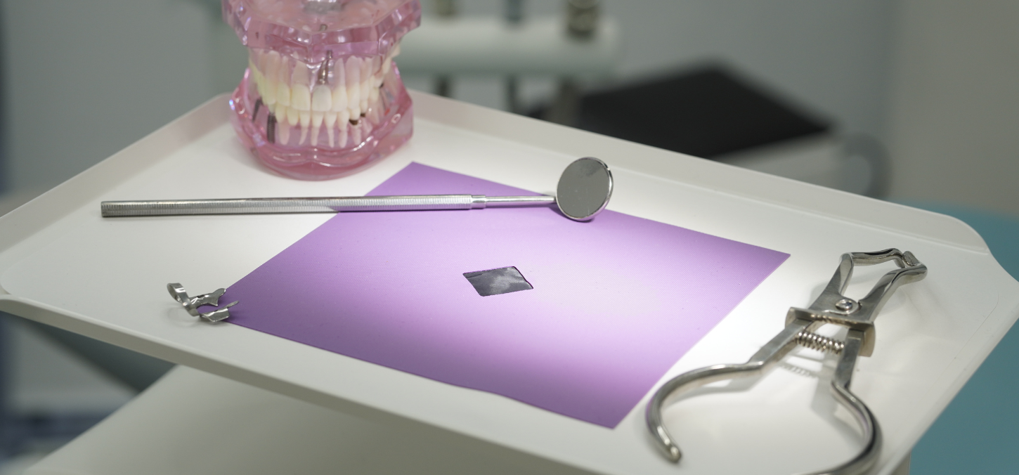 rubber dental dam next to dental equipment