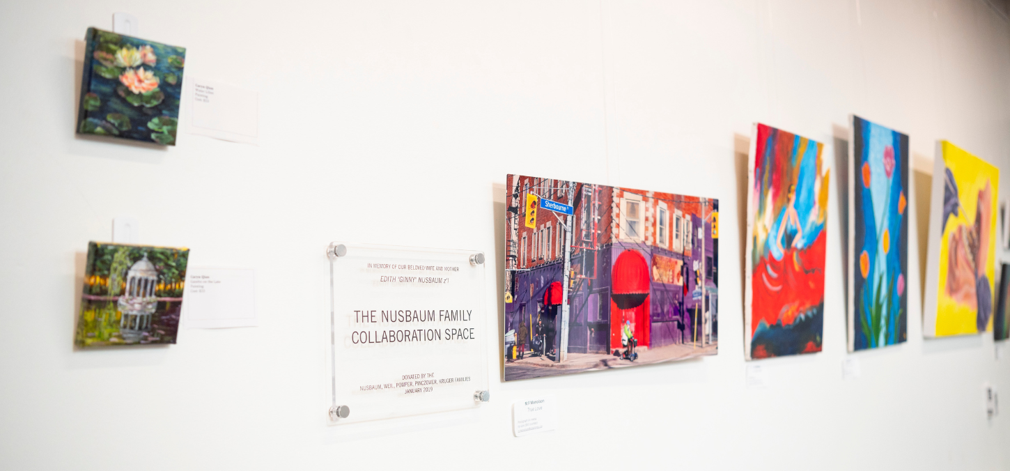 paintings and photos hanging on a wall