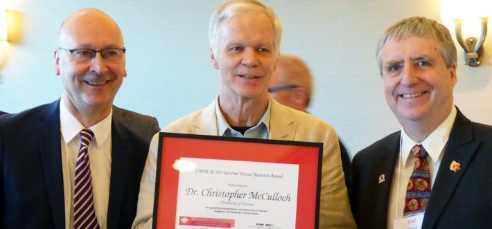 Chris McCulloch holding his award