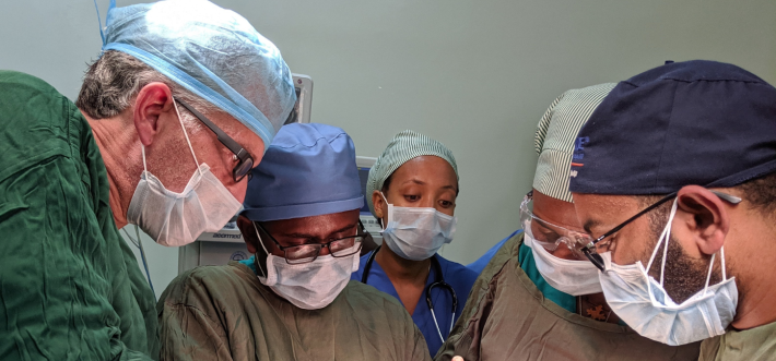 Dr. Caminiti (left) performing reconstructive surgery in St. Peters Hospital, Addis Ababa, Ethiopia, with local resident learners assisting and observing.