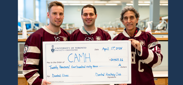 giant cheque with 3 people