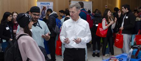 Photo of students interacting with sponsors at the Student Vendor Fair. 
