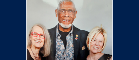 George standing with two classmates