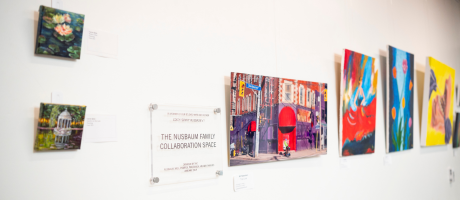 paintings and photos hanging on a wall